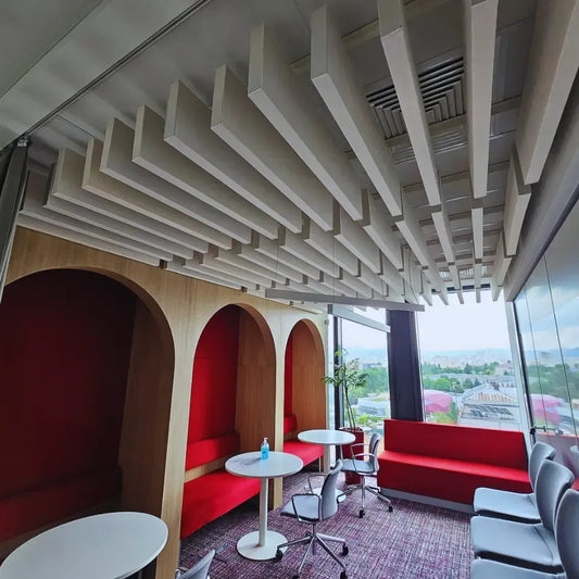 Office with wooden booths, red seating, and a decorative ceiling.