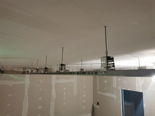 Interior construction with metal framework on ceiling.