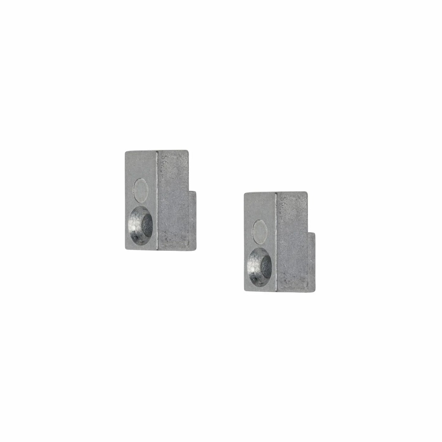 Two gray metal blocks with cylindrical holes.