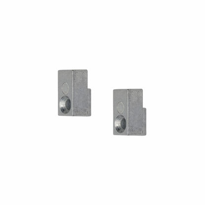 Two gray metal blocks with cylindrical holes.