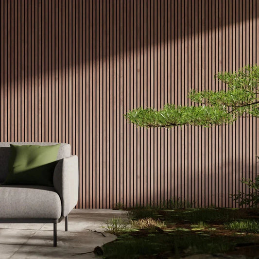 Interior shot: gray sofa with green cushion, wood-slatted wall, bonsai tree, grass.
