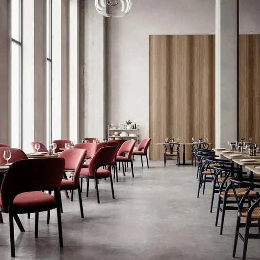 Restaurant interior with pink chairs and blue chairs.