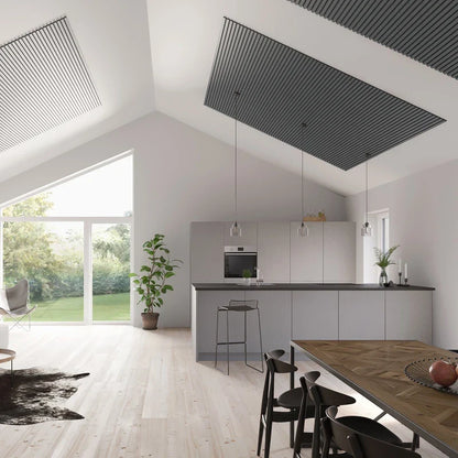 Bright, modern kitchen and living space with high vaulted ceilings and slatted ceiling panels.
