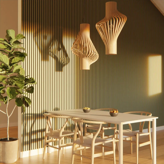 Dining room with light wood table, chairs, and wooden pendant lamps, with a potted plant on the floor.