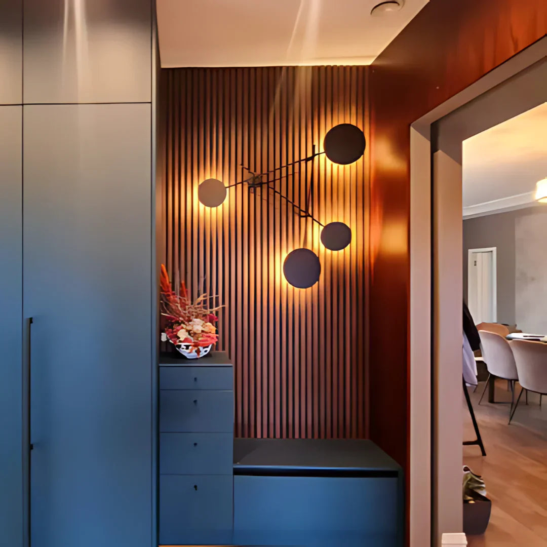 Stylish entryway with blue cabinetry, vertical wood paneling, and a modern light fixture.
