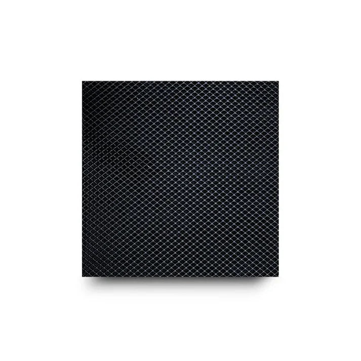 Close-up of a black diamond-patterned surface with a drop shadow.
