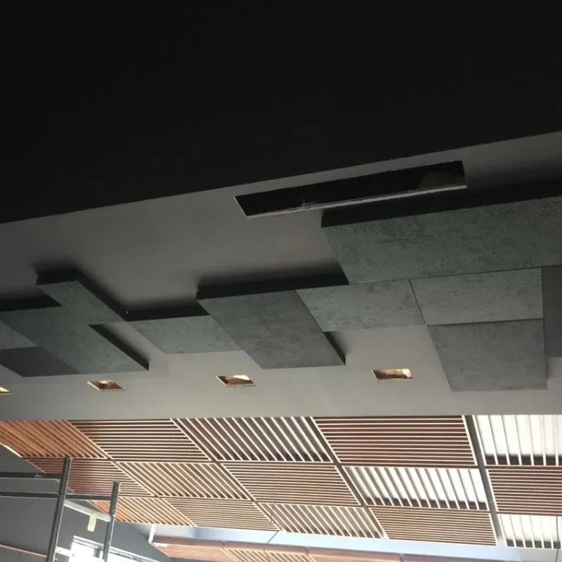 Ceiling with dark and patterned tiles, wooden slats, and recessed lighting.

