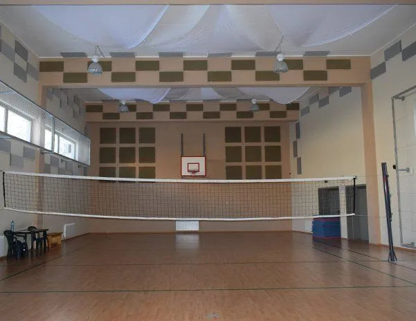 Indoor volleyball court with net.