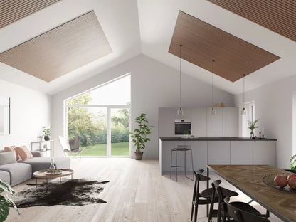 Bright open-plan interior with wood ceiling panels and large windows.
