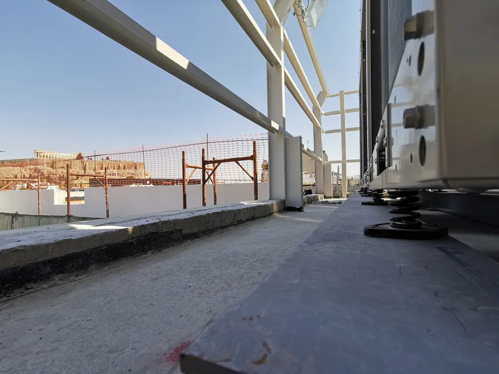 Exterior rooftop mechanical equipment with spring vibration isolators.