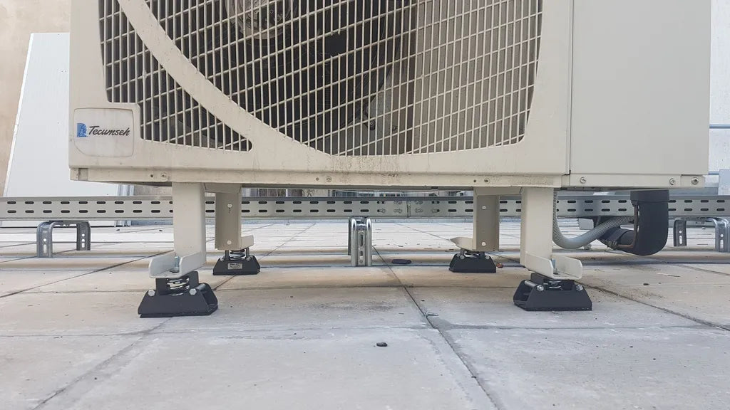 An air conditioning unit sits on vibration isolators.