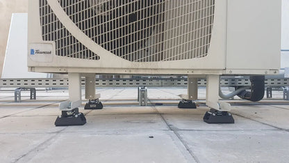 An air conditioning unit sits on vibration isolators.