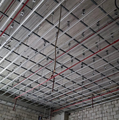 Exposed ceiling frame with red pipes.