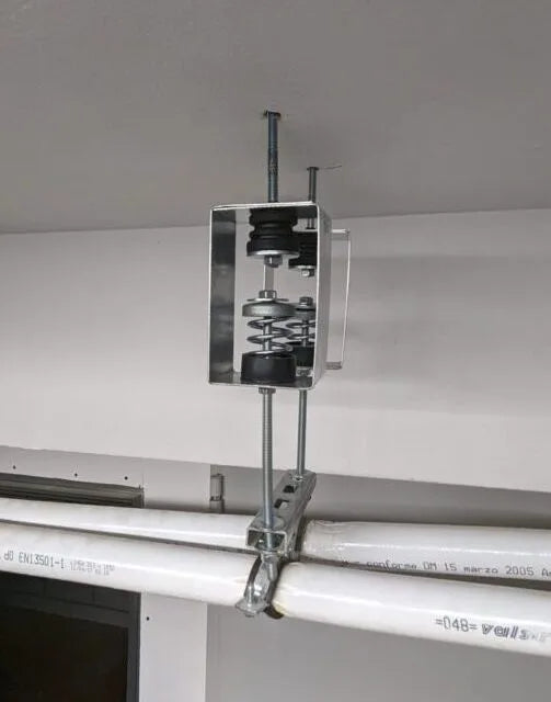 Mechanical vibration isolator attached to pipes.
