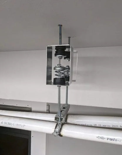 Mechanical vibration isolator attached to pipes.
