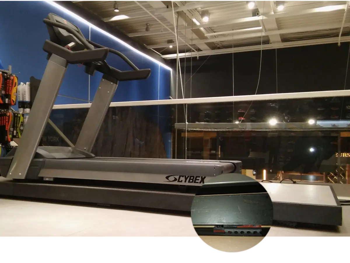A gray Cybex treadmill sits on a light-colored floor.