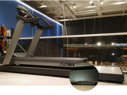 A gray Cybex treadmill sits on a light-colored floor.