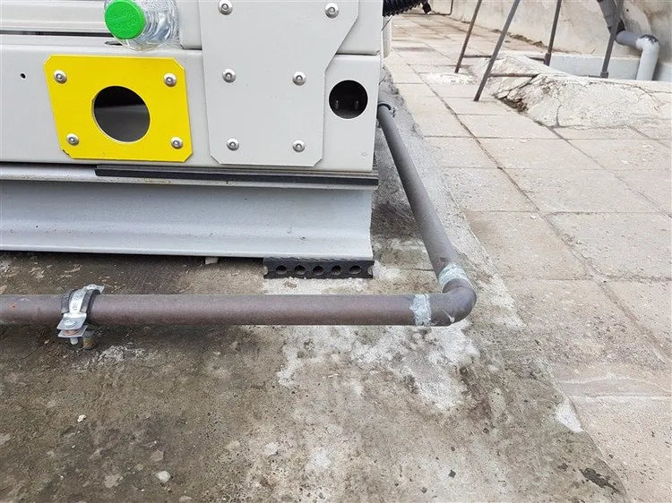 Close-up of pipes and a building exterior.