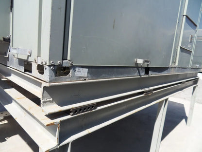 Exterior of a metal industrial air conditioning unit on a steel support frame.