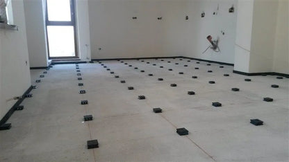 A floor with black risers for leveling.