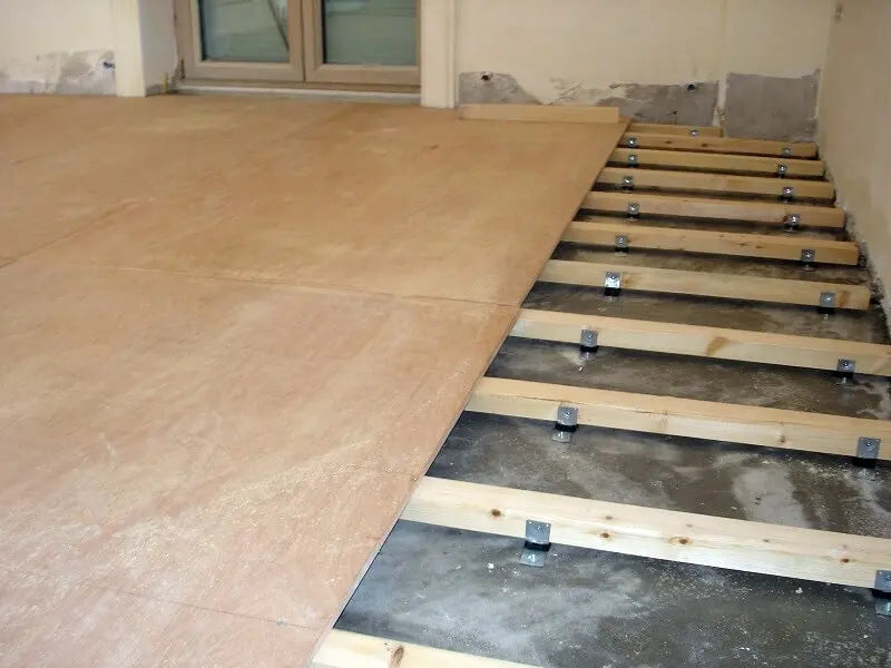 Plywood being installed over a raised subfloor.