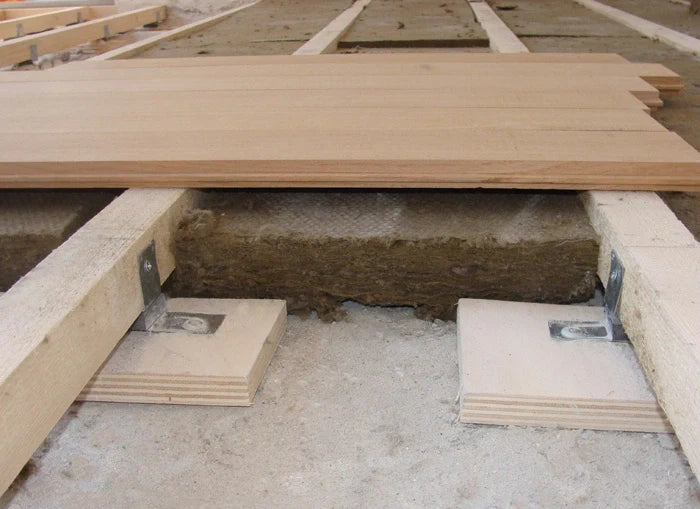 Under-floor insulation with wooden supports and flooring.