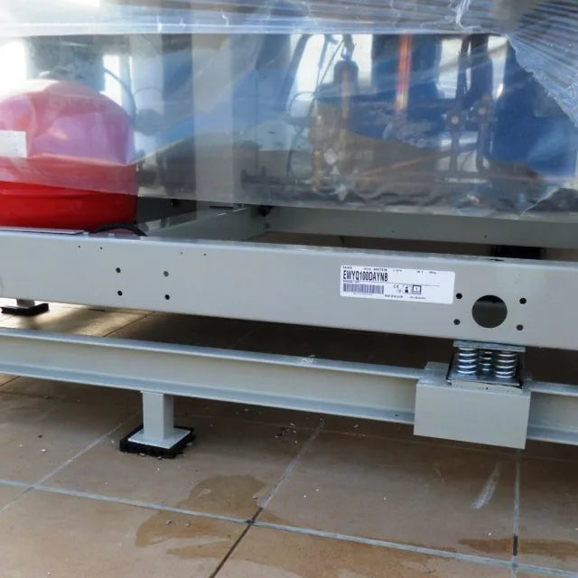 Industrial equipment with springs on tiled surface.