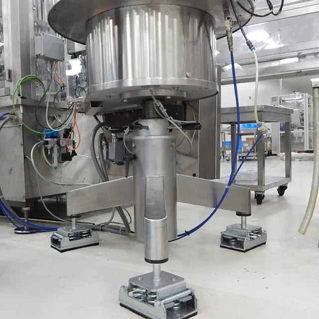 Close-up of industrial machine on vibration dampening mounts.