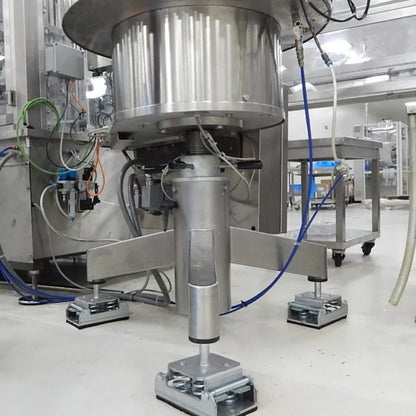 Close-up of industrial machine on vibration dampening mounts.