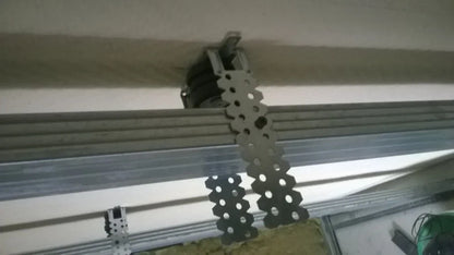 Ceiling insulation installation with metal support strips.