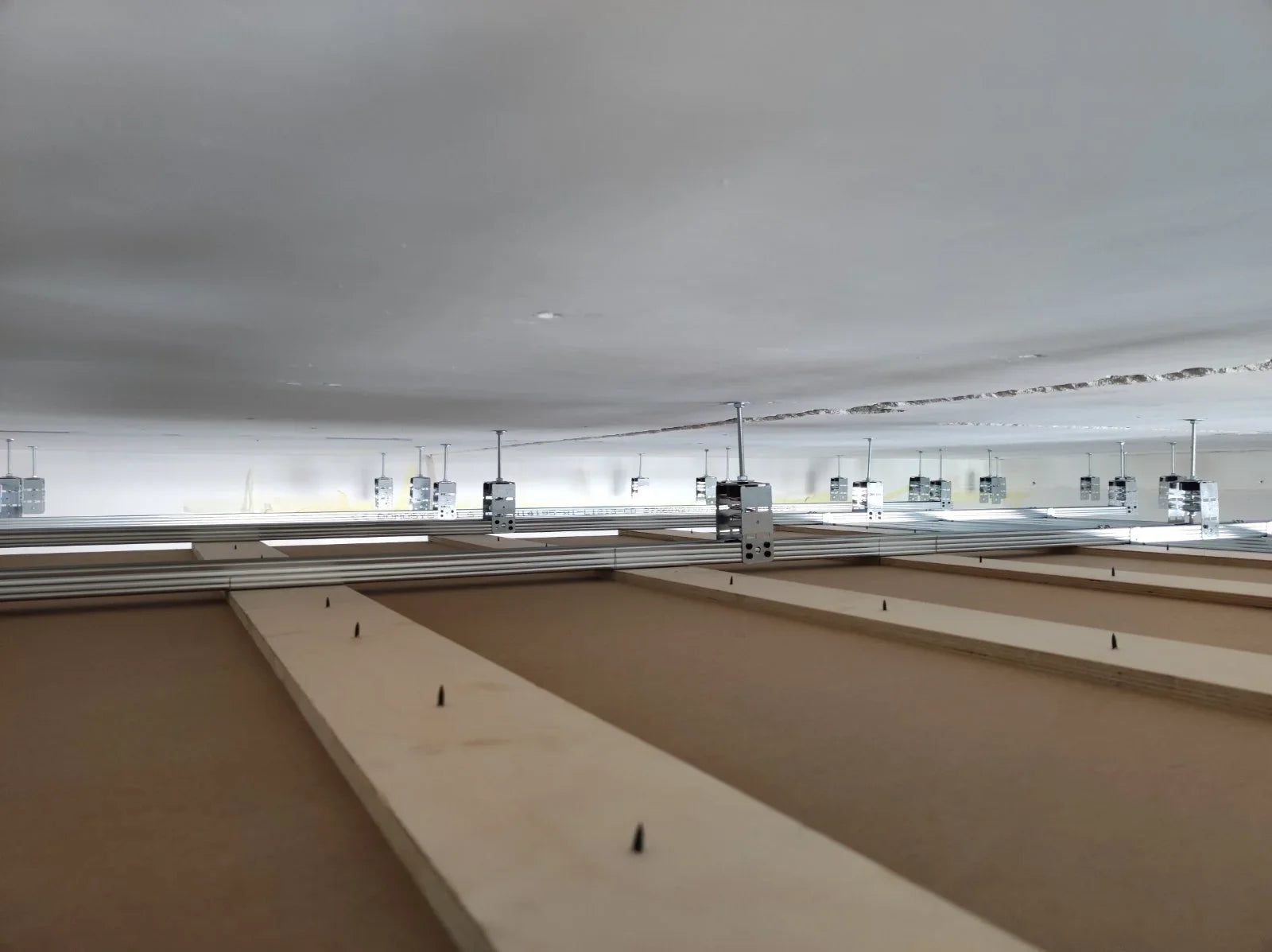 Overhead shot of ceiling framing with metal supports.