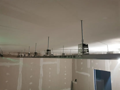 Interior construction with metal framework on ceiling.