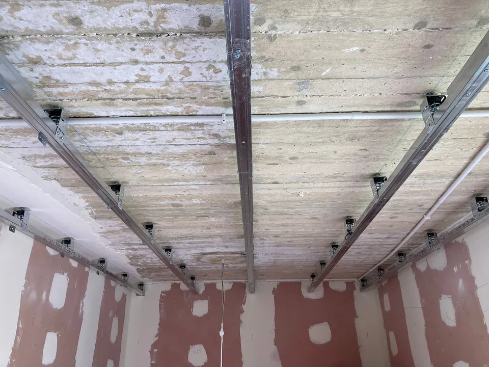 Interior of a room with metal framing and a concrete ceiling.