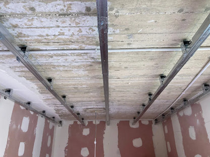 Interior of a room with metal framing and a concrete ceiling.
