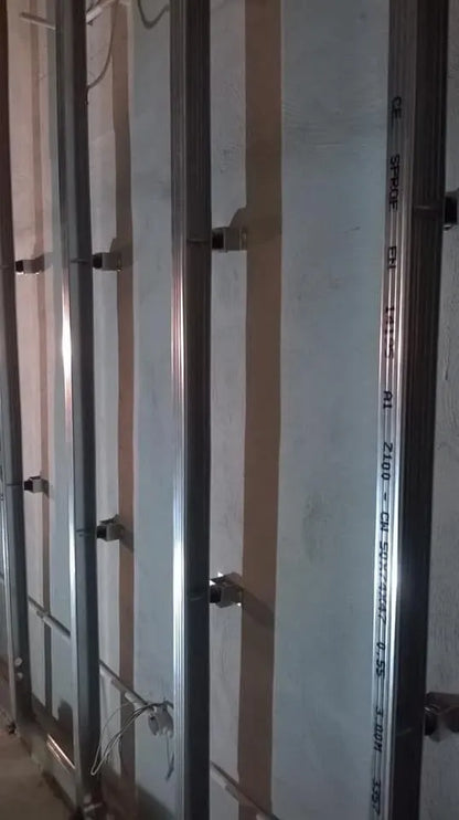 Metal studs on a white wall. Electrical wiring is exposed.