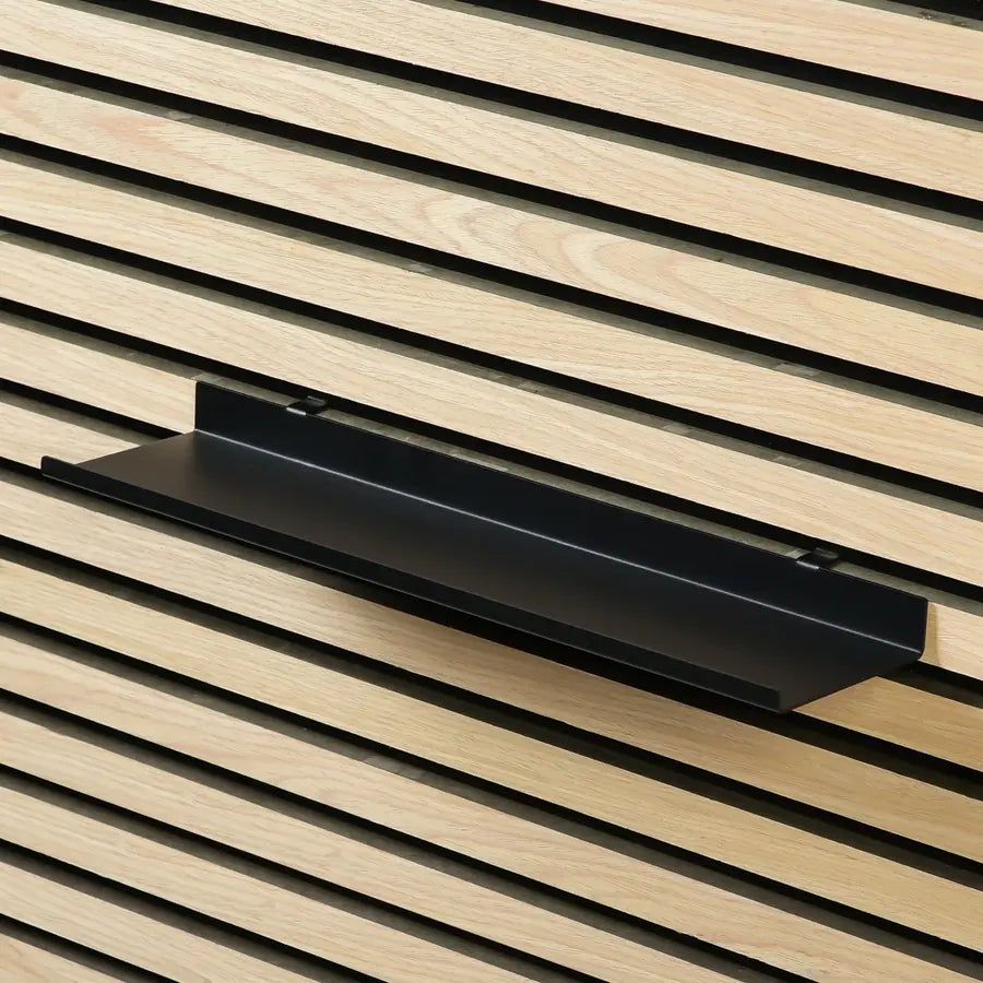 Black shelf on wood slat wall.
