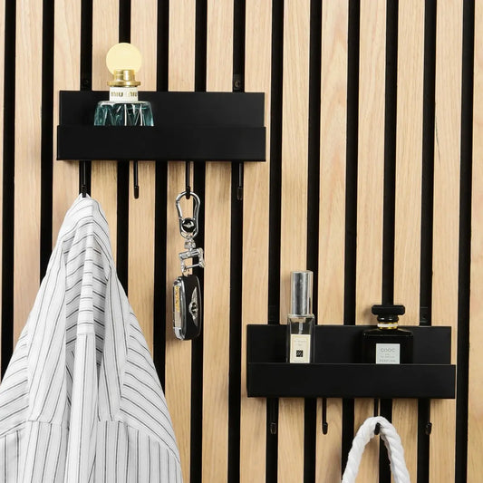 Wall-mounted coat racks with shelf, black, light wood, perfume bottles, shirt, keys, purse.
